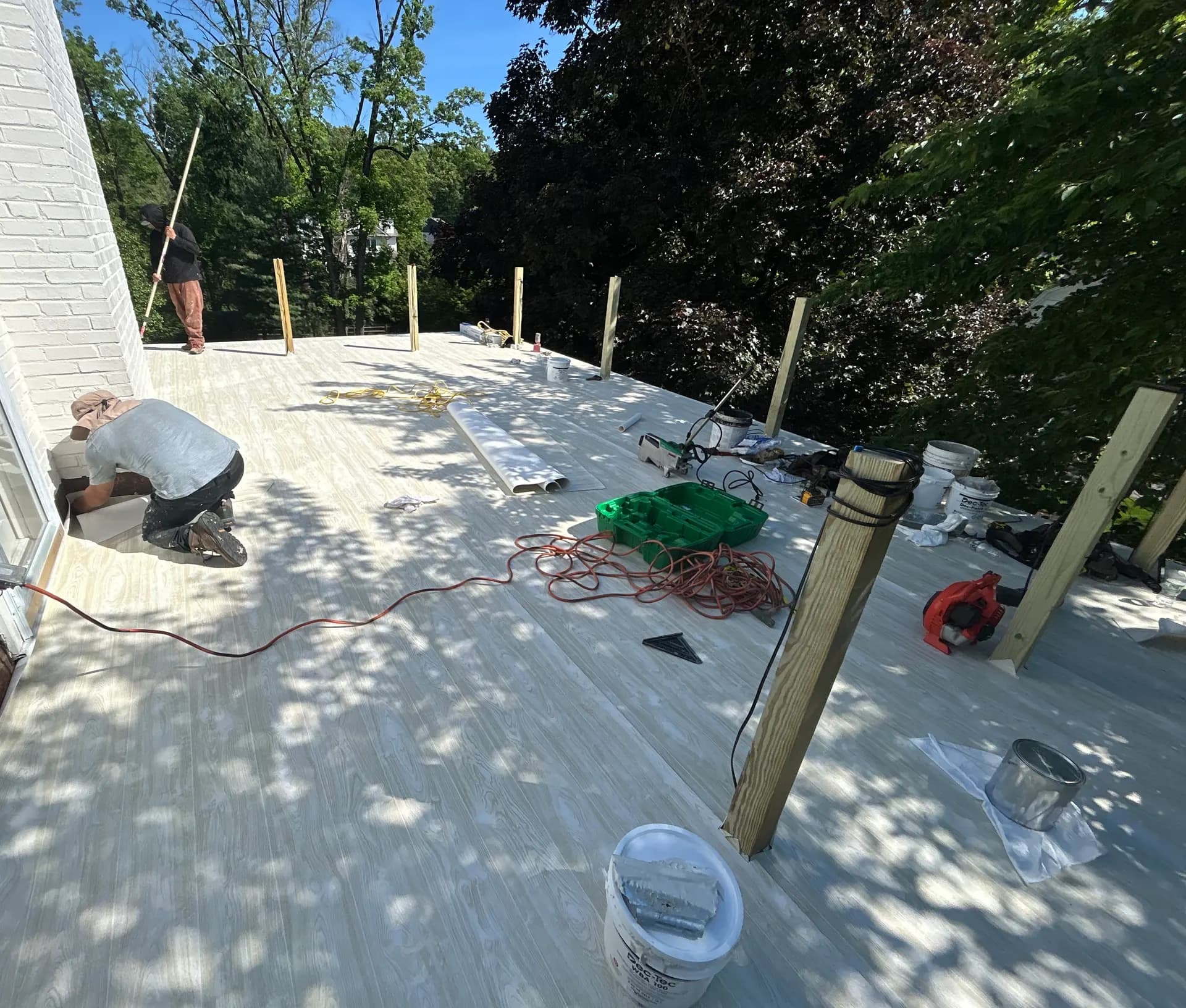 Father & Sons family crew installing composite decking boards on-site in New Jersey