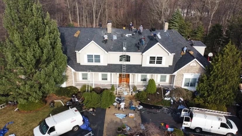 Father & Sons crew completing a full roof replacement on a large NJ home, aerial view